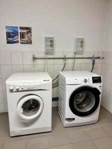 a washing machine and a washer in a room at Chalet Auszeit Montafon in Bartholomäberg