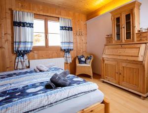 a bedroom with a large bed and a window at Chalet Auszeit Montafon in Bartholomäberg
