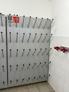 a locker room with white dividers on a wall at Chalet Auszeit Montafon in Bartholomäberg +6 photos