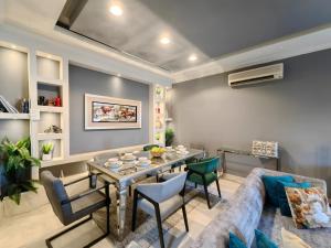 a living room with a couch and a table at High Residence - Spacious & Lux Apt in Muscat