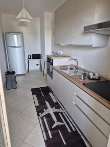 a kitchen with a sink and a refrigerator at mirosa airport home in Macchie