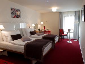 a hotel room with two beds and a couch at EA Hotel Tereziánský dvůr in Hradec Králové +72 photos