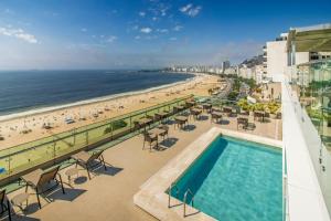 a view of the beach from the balcony of a resort at Arena Copacabana Hotel in Rio de Janeiro +59 photos