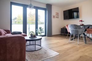 a living room with a couch and a table at Heimbi-Home No 4, 4 People, EuropaPark, E-Ladesäule in Kappel-Grafenhausen