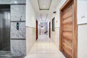 a corridor in a hospital with a door at Hotel City Lite Near Delhi Airport in New Delhi