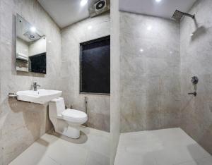 a bathroom with a toilet and a sink at Hotel City Lite Near Delhi Airport in New Delhi +34 photos