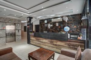 a lobby of a hotel with a reception counter at Hotel City Lite Near Delhi Airport in New Delhi