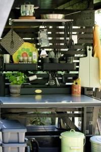 a table with dishes and a phone on top of it at Small Cabin With Outdoor Kitchen By Forest Stream in Trollhättan