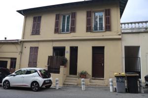 a white car parked in front of a house at Cozy apartment in Nice Est in Nice