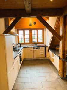 a kitchen with white appliances and wooden ceilings at Haus Itten in Hondrich +32 photos
