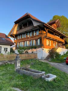 a large wooden house with a fence in front of it at Haus Itten in Hondrich