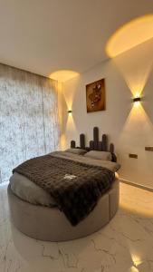 a bedroom with a large bed in a room at Amour Homes in Quba