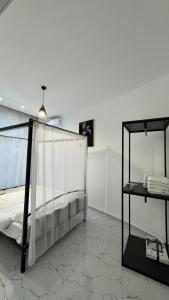 a bedroom with a bed with a canopy at Amour Homes in Quba