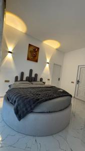 a bedroom with a large bed with a black blanket at Amour Homes in Quba