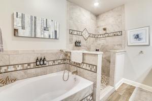 a bathroom with a tub and a sink at Private Dock and Yard! Modern Getaway in Mabank in Enchanted Oaks +25 photos