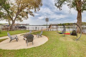 a park with chairs and a playground with a slide at Private Dock and Yard! Modern Getaway in Mabank in Enchanted Oaks