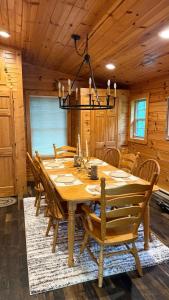 a dining room with a wooden table and chairs at The Cozy Family Wabasha Cabin in Wabasha +13 photos