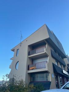 a building with balconies on the side of it at Jolie T2 en plein centre-ville ville de Font-Romeu in Font Romeu Odeillo Via