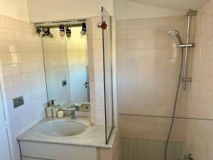 a bathroom with a sink and a glass shower at La Terrazza in Piobesi dʼAlba