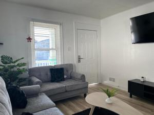 a living room with a couch and a table at Vibes Villa in Wildwood