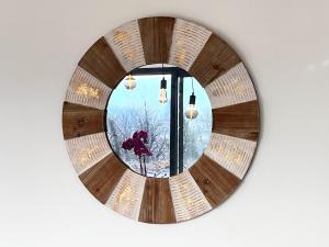 a mirror hanging on a wall with a window at Maison neuve Jacuzzi et Piscine Haut de Gamme in Vallon-Pont-dʼArc +22 photos