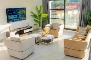a living room with two chairs and a table at Sweet Apartment in Tanga