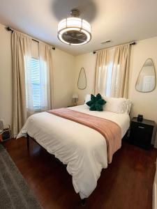 a bedroom with a large white bed with a plant on it at POEs Place in Panguitch