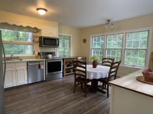 a kitchen with a table and chairs in a kitchen at Unique Ski Rental in Berkshires Charlemont Near Hawley State Forest, Plainfield, Western Massachusetts in Plainfield