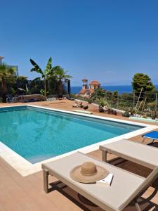 a swimming pool with a hat on top of it at Rastoni Suites Xylokastro 1 in Melission