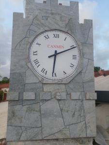 a large clock on top of a stone wall at Canmin Guest House in Galle