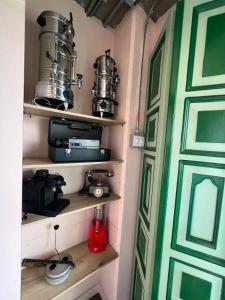 a room with shelves with pots and pans and a door at Candilejas in Fredonia +8 photos