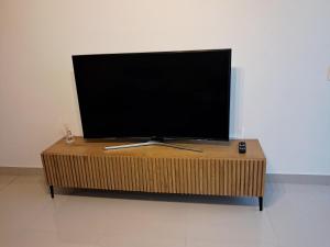 a flat screen tv sitting on top of a wooden table at Naledi Holiday Apartment in Durban