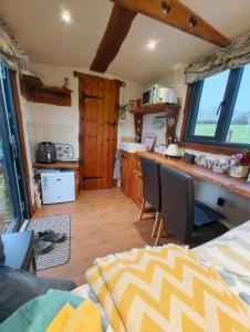 a kitchen with a table and chairs in a room at Y Cwtch in Trefeglwys