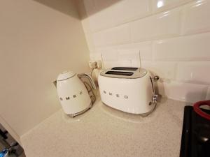 a toaster sitting on the floor in a kitchen at Naledi Holiday Apartment in Durban
