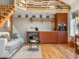 a living room with a couch and a table at The Coal House in Skipton