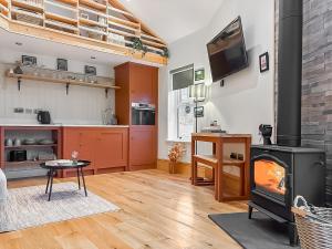 a living room with a fireplace and a stove at The Coal House in Skipton