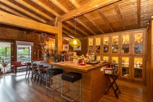 a kitchen with a large island with bar stools at Casa da Almoinha in Unhais da Serra