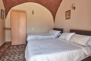 a room with two beds and a door in it at Sun Temple Palace in Cairo +35 photos