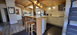 a kitchen with a island in a tiny house at Chalet Mugnier in Samoëns +26 photos
