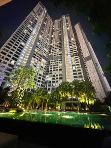 a large building with trees in front of it at night at Agile bukit bintang trx by klcc sky view in Kuala Lumpur