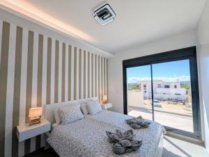a bedroom with a bed and a large window at R-40-E Esplendor in Los Montesinos +21 photos
