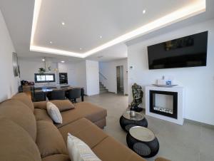 a large living room with a couch and a television at R-40-E Esplendor in Los Montesinos