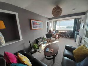 a living room with a couch and a table at Clisham Bed and Breakfast in Lochcarron