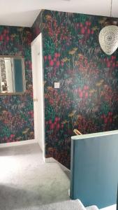 a room with a wall covered in red flowers at Clisham Bed and Breakfast in Lochcarron