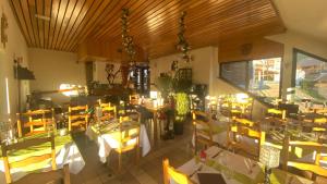 an overhead view of a restaurant with tables and chairs at Auberge le bois du cornet in La Forclaz