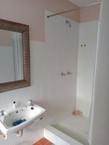 a white bathroom with a sink and a shower at Gemma in Mossel Bay