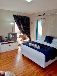 a bedroom with a bed with two pillows on it at Gemma in Mossel Bay