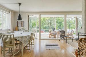 a kitchen and dining room with a table and chairs at Cottage With Private Lake And Sauna Near Näshult in Åseda