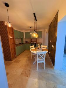 a kitchen and dining room with a table and chairs at Ultracentral 1 Craiova in Craiova