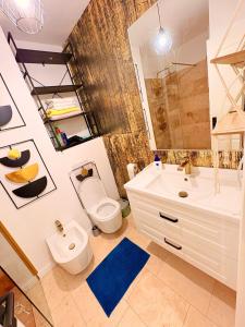 a bathroom with a toilet and a sink at Ultracentral 1 Craiova in Craiova +13 photos